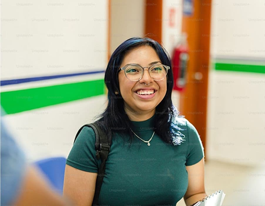 Female Student wearing a green shirt and glasses
